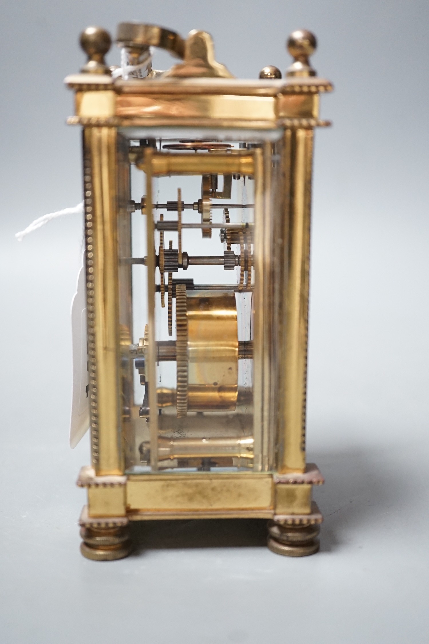 An Edwardian brass carriage timepiece, with pearl applied dial, 12cms high